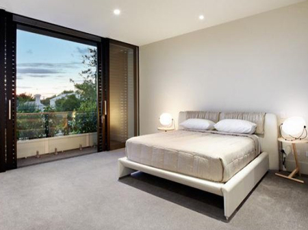 bedroom with sliding louvres and glass doors