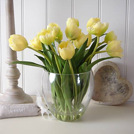 yellow tulips in glass vase