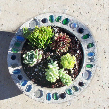 Make a decorative concrete planter with pebble or mosaic
