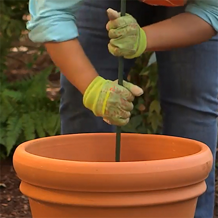 place the garden spike or steel rebar through the base of the pot for your herb tower