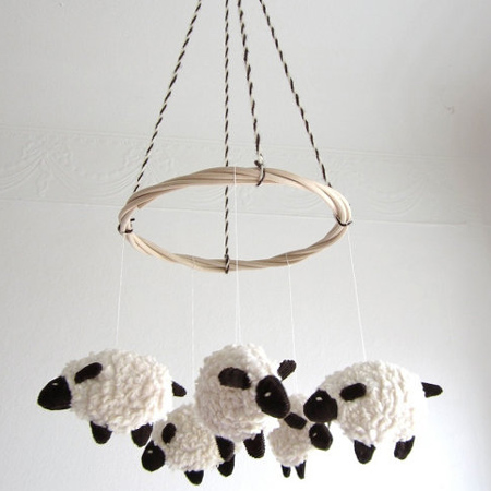 Decorate a gender-neutral nursery with a lamb or sheep theme, woolly lamp mobile