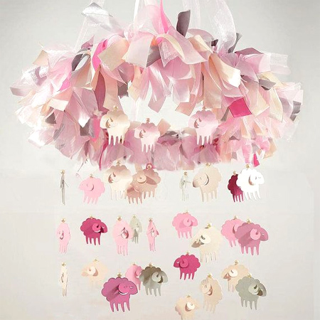 Decorate a gender-neutral nursery with a lamb or sheep theme, pretty pink, grey and white lamp mobile