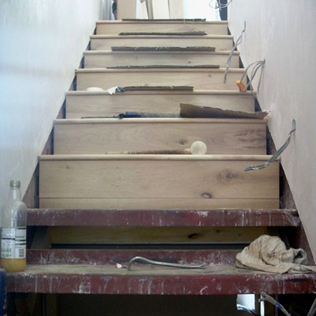 clad steel staircase with laminated wood flooring risers and steps