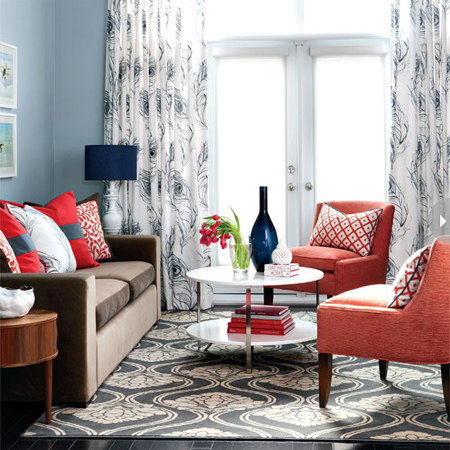 Update your interior living spaces with the calming effect of blue. In this open plan living and dining area, pale blue walls create a cool backdrop for warmer colours that include red, coral and brown. 