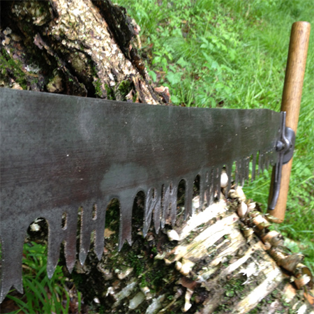 A crosscut saw is available in two versions: one that cuts on the push stroke for single-person use, and one that cuts on both the push and pull strokes when handled by two people