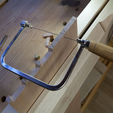a coping saw allows you to make detailed cuts in wood. The fine-toothed blade can be easily rotated and used at any angle to cut curves or shapes