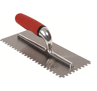 use a notched trowel to apply tile adhesive to wall