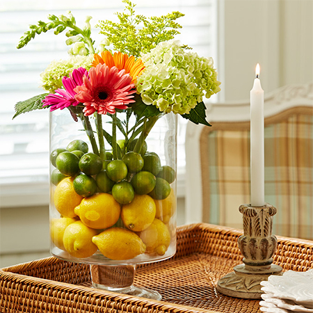 fill vase with lemon lime and fresh flowers for a colourful zesty table centrepiece