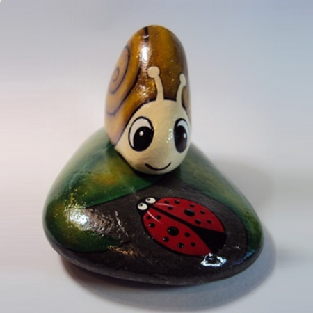 painted pebble snail on rocks