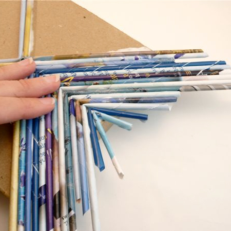 glue rolled recycled magazine tubes onto a shoebox for kids craft project ideas