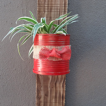 Recycled can plant holder on reclaimed wood stand and painted with rustoleum 2x satin poppy red spray paint