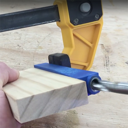 2. Place the jig against the end of your block of wood and clamp firmly in place.