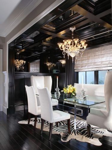 The black vaulted ceiling and cabinetry provide a dramatic backdrop for this modern dining room
