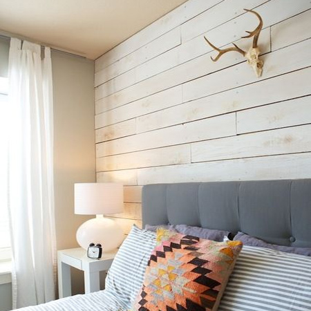 DIY plank wall in a bedroom painted white