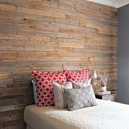 DIY reclaimed timber plank wall in a bedroom