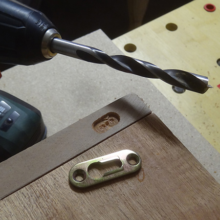Use a 10mm wood bit to drill out to a 5mm depth. 