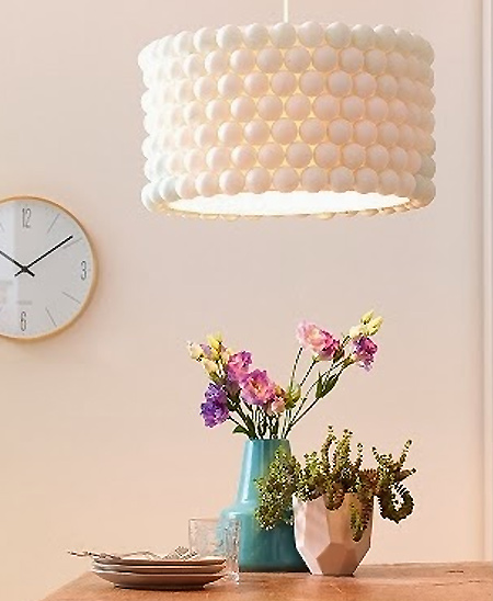 Dress up a plain lamp shade by gluing ping pong balls around the shade itself. The one shown here is a simple white ping pong shade, but imagine the look if it was sprayed in a metallic finish