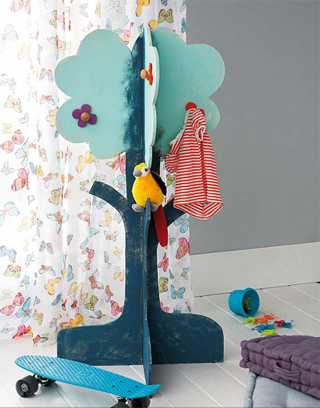 A wooden coat tree painted to match a bedroom