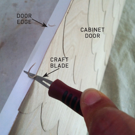 You can use a rubber roller or rolling pin to press down over the veneer and remove any trapped air bubbles. Once dry, after about an hour, use a sharp craft blade to trim away any rough edges and lightly sand with 240-grit sandpaper.