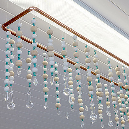 Here's how to turn an ordinary fluorescent lighting fitting into an eye-catching feature using affordable materials and assorted glass and wood beads