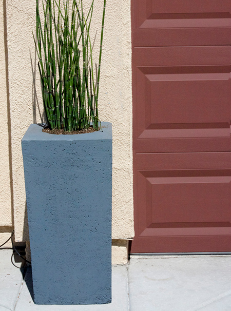 When shopping for concrete planters for my front entrance, I could not believe how expensive these are. Rather than spend a fortune, here's how to make your own concrete planters.
