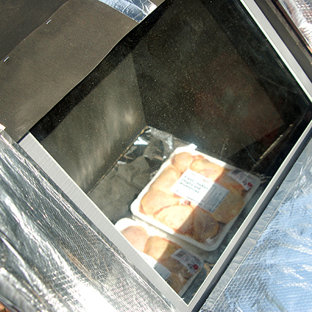 ABOVE: After assembly and fitting the reflective panels I tested the solar oven. Two packs of frozen chicken took 20 minutes to completely defrost. I plan on testing the solar oven for slow cooking and will report back on this.