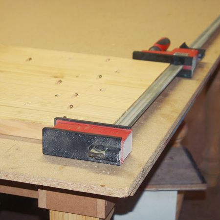bessey clamps hold top planks together until glue dries