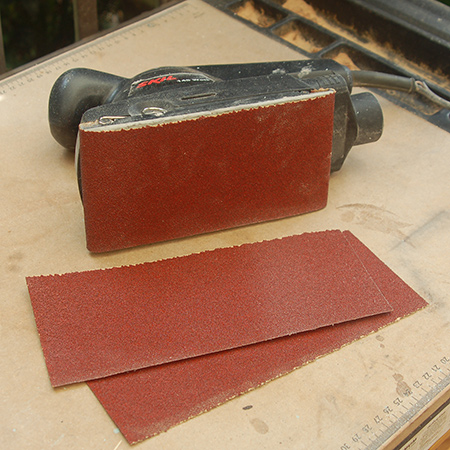 sheet of sandpaper can be divided into three strips for fitting onto the base of the sander