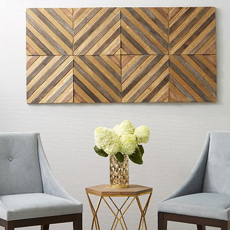 Thin boards of differing heights are glued together and mounted onto a feature wall in opposing directions to create a visually interesting display.