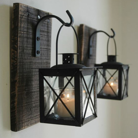 Scrap planks of rough cut timber fitted with steel brackets can be used to hang votive lanterns. Spray brackets and lanterns with Rust-Oleum High Temperature matt finish spray paint.