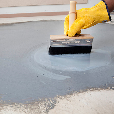 TAL Keymix slurry is brushed onto the surface with a builder’s block brush