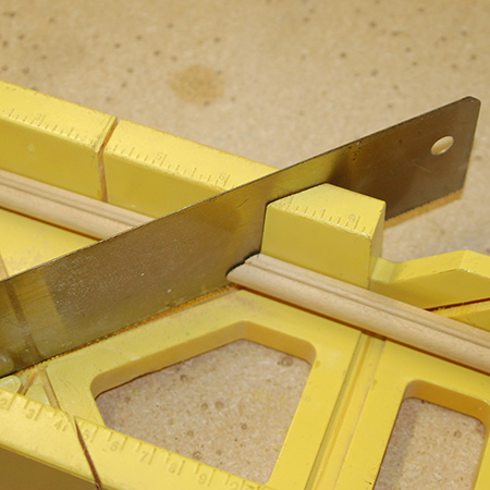 2. Use a mitre box and backsaw to cut opposing 45-degree angles. 