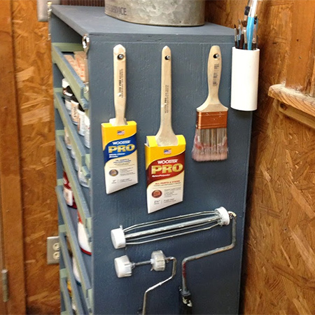 Add some hooks to the side of the cabinet for hanging paintbrushes and paint rollers. 