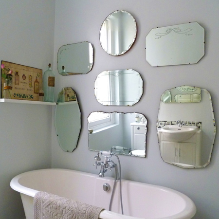 Decorating a bathroom wall with vintage mirrors adds instant bling to a plain bathroom. Here's how to create your own mirror wall.