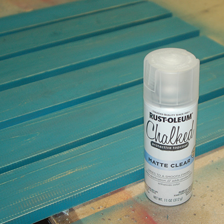 After wiping clean, shake the can before applying Rust-Oleum Matte Clear Coat over the painted surface. This offers protection for the table top.