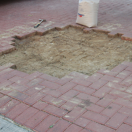 After removing all the paving bricks, soil is packed into the area to level it out. This then needs to be compacted using a manual or mechanical tamper. For a small area you can tamp down the area using a heavy hammer, but it is recommended that you hire a mechanical tamper for larger areas.