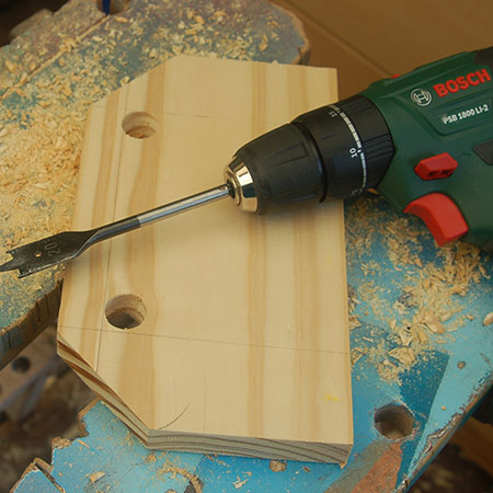 4. Drill two holes with a 20mm spade bit.