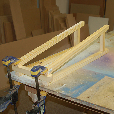3. Use wood glue to secure the legs to the top crosspieces - at the 5-degree angled cut. Clamp overnight.