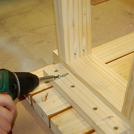 9. Place the bench face down on the slats in order to mount the bottom frame to the underside of the seat slats