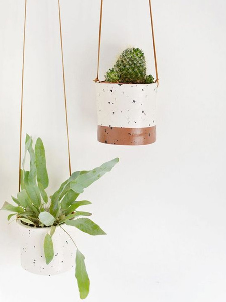 For plants that require little or hardly any water, like cactii or air plants, you can consider using air-dry clay to craft your own unique pots for plant hangers. 