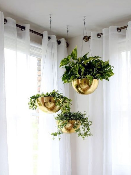 You wouldn't think that plastic bowls would make attractive plant holders, but give them a coat or two of Rust-Oleum Universal metallic spray paint and you have affordable planter hangers that look stunning. 