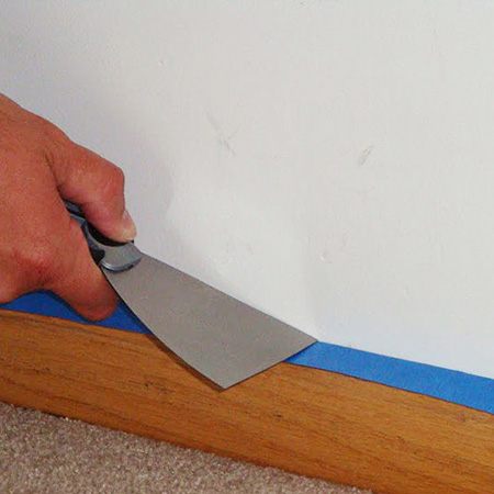 Apply painter's tape over the edge of skirting boards before painting