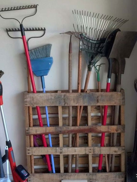 In the absence of a garden shed, garages end up as a place to dump garden tools and accessories. An easy way to organise and store these is to create a storage, or hanging rack, where they can be placed. A reclaimed pallet is a very easy way to make a storage rack for all your garden tools - no effort required.