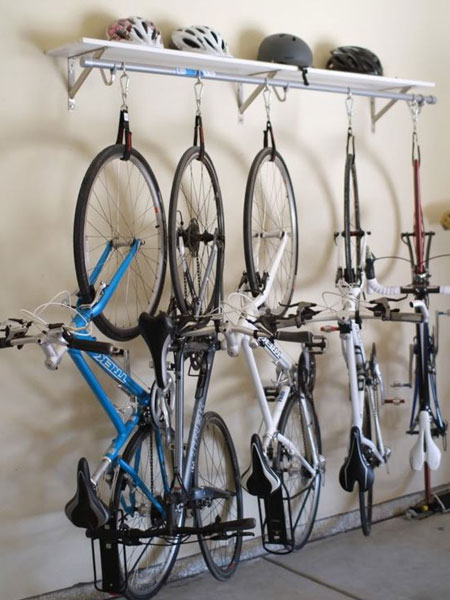 Use hooks and nylon dog collars to suspend bicycles from a securely mounted wall shelf - brilliant!