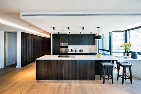 HOME-DZINE | Interior Design - In the kitchen zone, an island clad in natural oak with a polished marble countertop