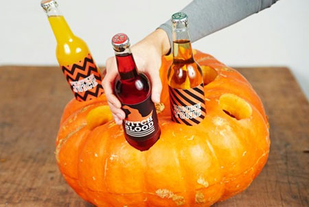 HOME-DZINE | Craft Ideas - Fill a bowl with ice cubes and place in the lower half of the pumpkin. Pop the pumpkin lid on top and fill with bottles. Now your guests can enjoy the spooky drinks that go with a Halloween party