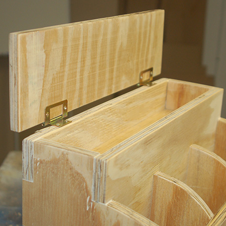 10. Attach the lid onto the storage compartment with butt hinges. Make sure the barrel of the hinge rests over the edge of the back so that it opens and closes properly. 