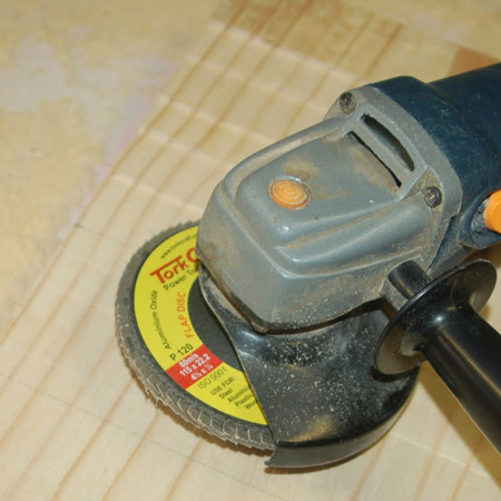 4. Now you’re going to turn your angle grinder into a sander by adding a 120-grit flap disc. You can buy Tork Craft Flap Discs at most larger hardware stores. 
