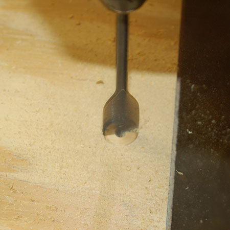 9. Before mounting the door, use a 25mm spade bit to drill out the finger hole. 