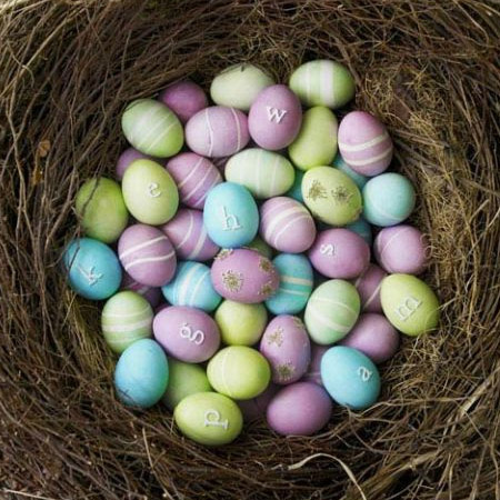 Here's another colourful Easter egg display. The eggs are dyed in lavender food colouring and then painted with white swirls. To create the swirls, wrap the eggs with an elastic band before dyeing.